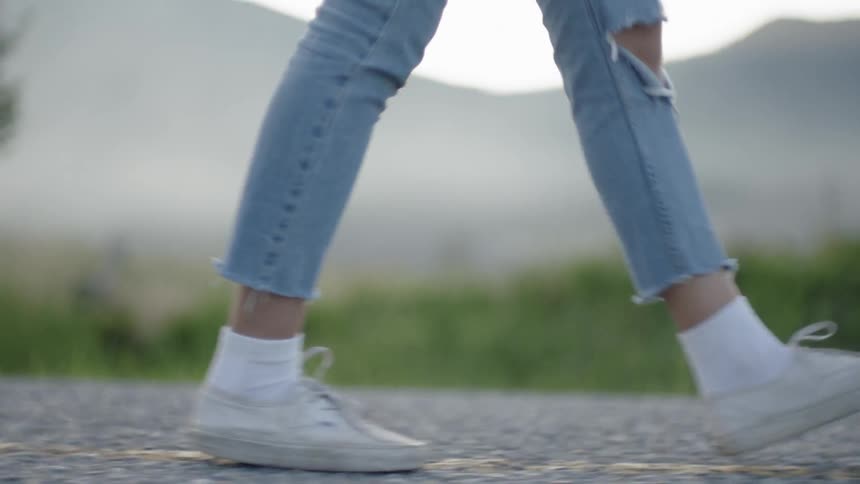 Woman walking on a concrete road