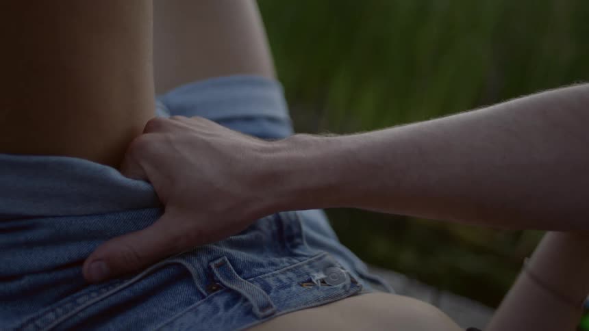 A person pulls at their shorts