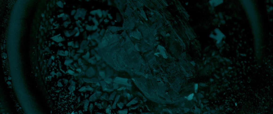 A piece of glass shatters into many pieces