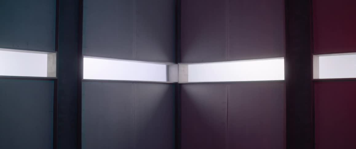 A large rooms has windows lining the center
