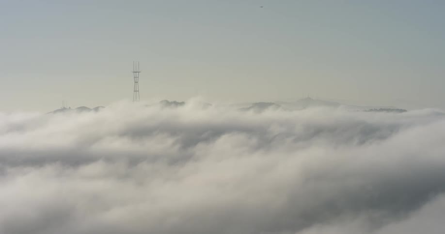 A thick bank of fog rolls past an antenna