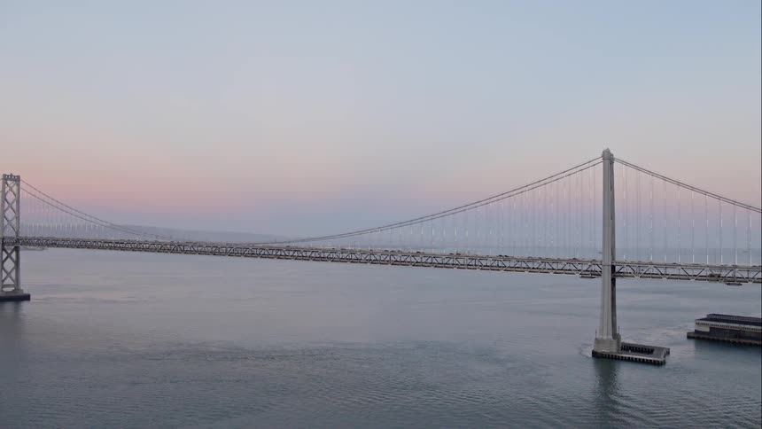 Cars cross a bridge atop a large body of water