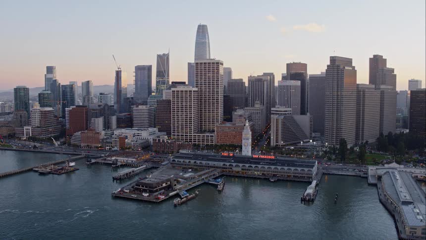 Docks stretch out over water next to a huge city
