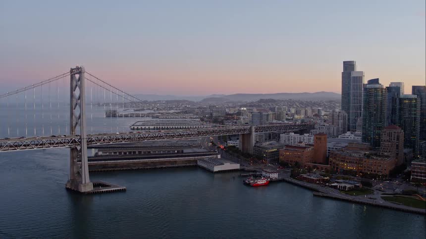 Skyline of the city where vehicles go over the bridge at dusk