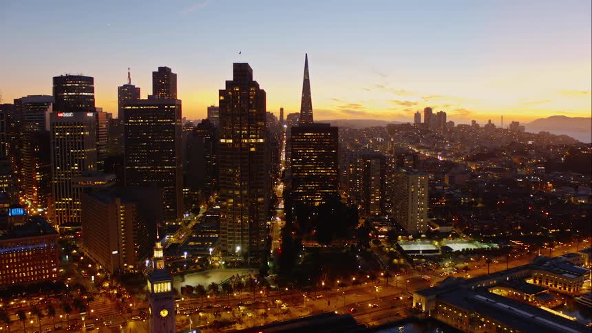 Aerial of the city at night shining bright with many lights