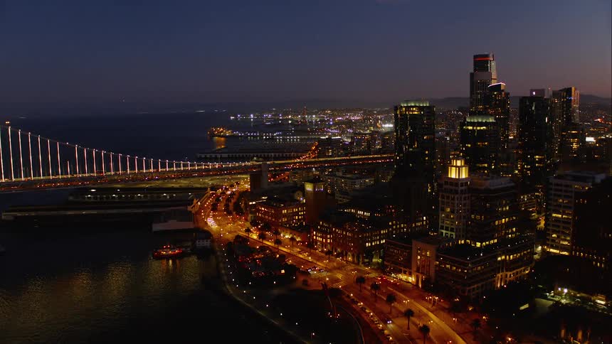 Aerial of a metropolis city at night with lights shining brightly