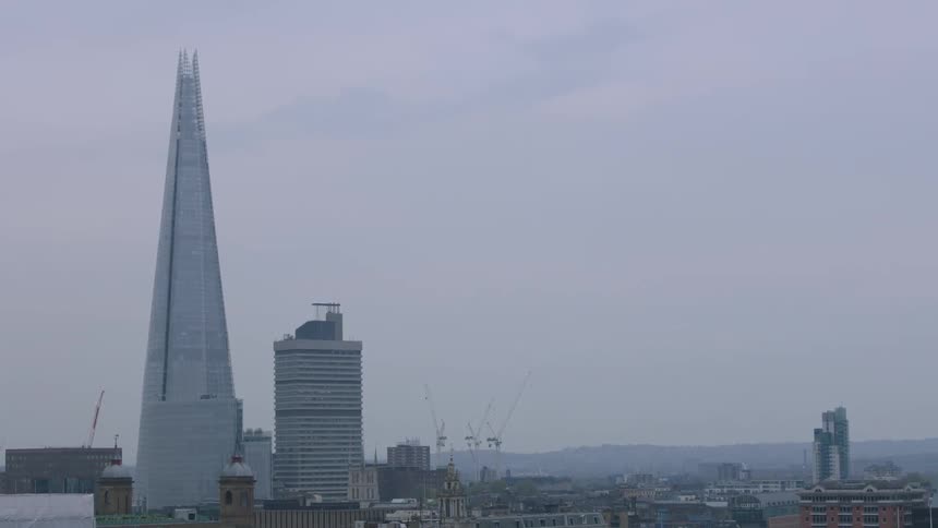 A foggy city skyline is shown