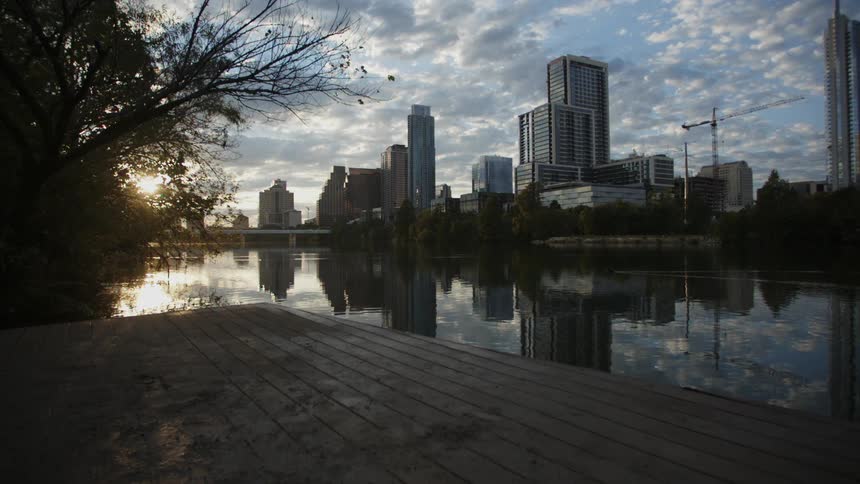 A city skyline is shown during the dusk