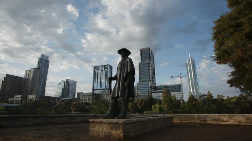 Metal statue of a man holding a gun