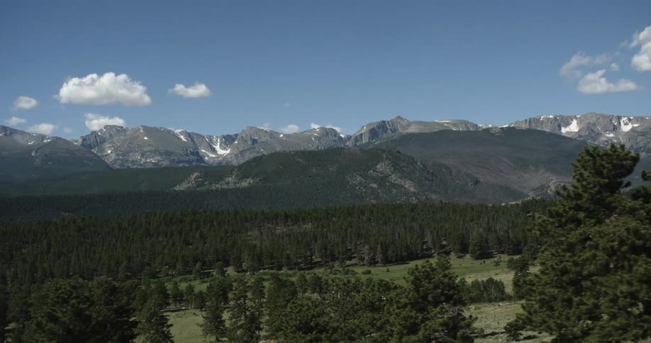 A mountain range with a forest at the basin