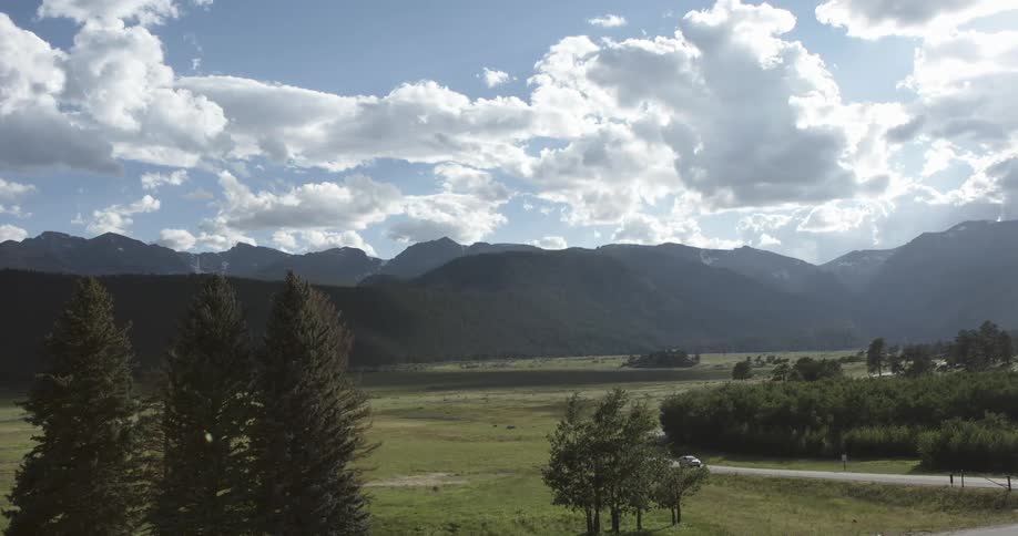 Aerial view of open plains with mountains in the background