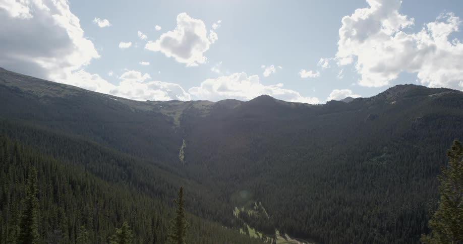 A large mountain range can be seen on a sunny day