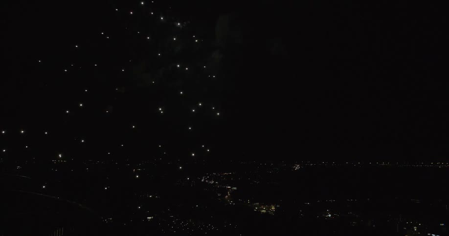 Fireworks shoot into the sky and explode at night