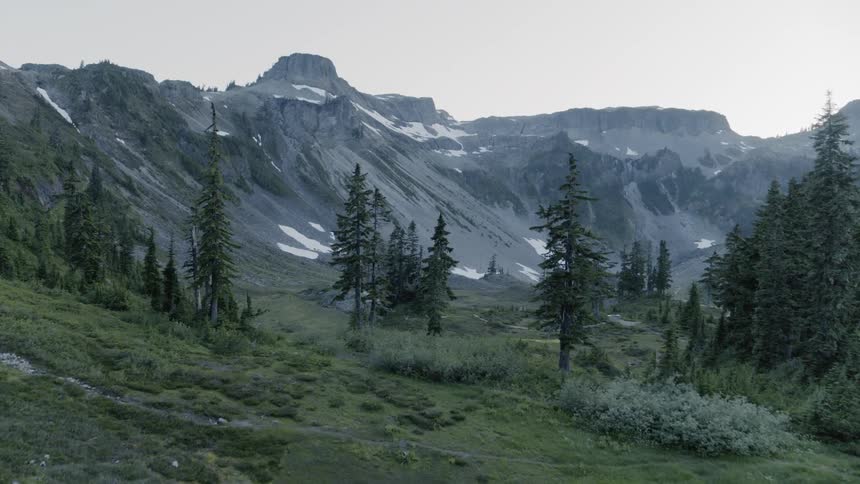 Mirror lake mountainside reveal thru the trees