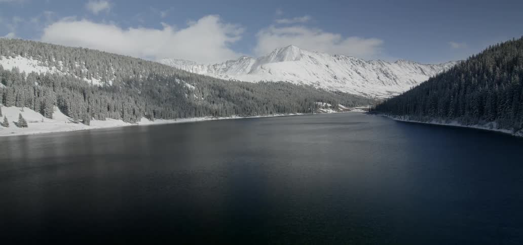 A large body of water fills in a mountain valley