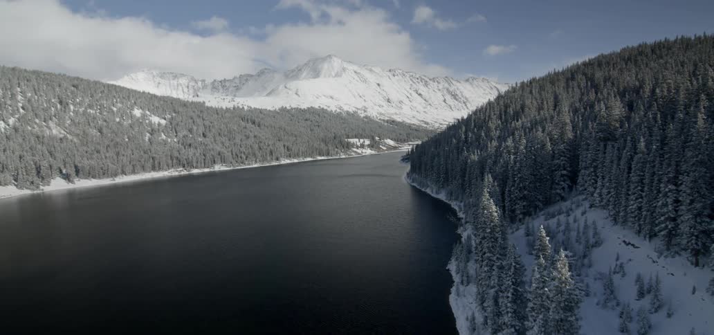 Aerial view of a river surrounded by mountains and forests
