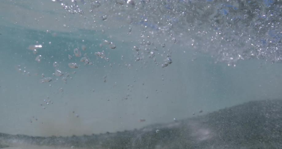 Manta ray swims past near sea bottom