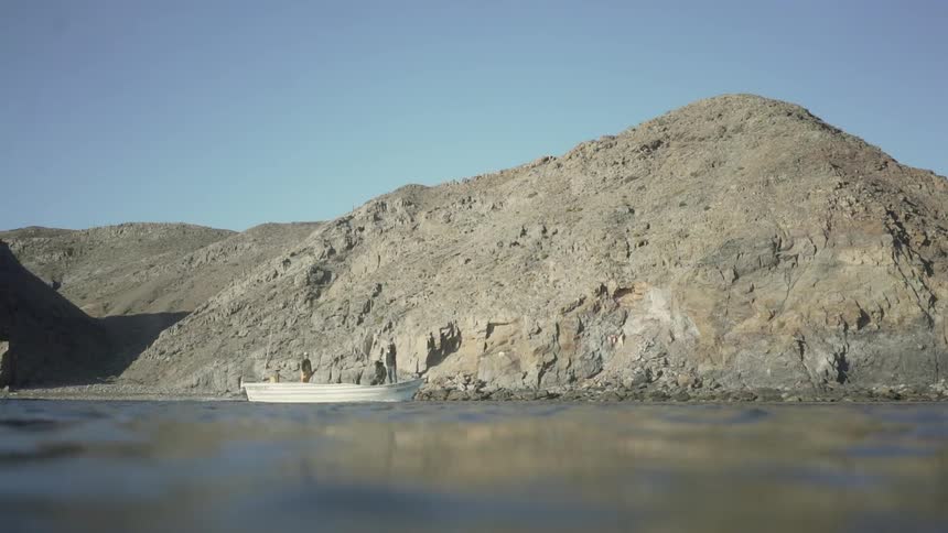 A group of men are fishing down a river