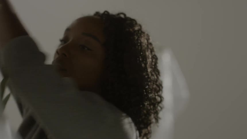 Young black girl walking towards a plant and unwrapping it