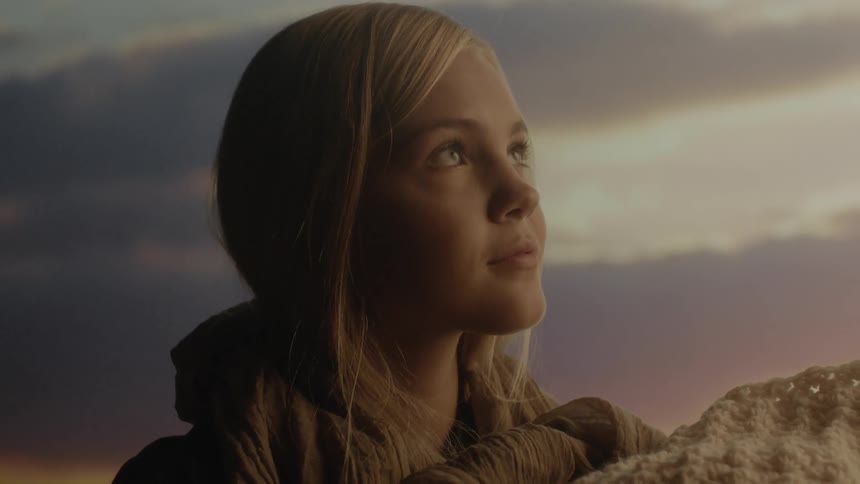 A young girl looks ahead at something