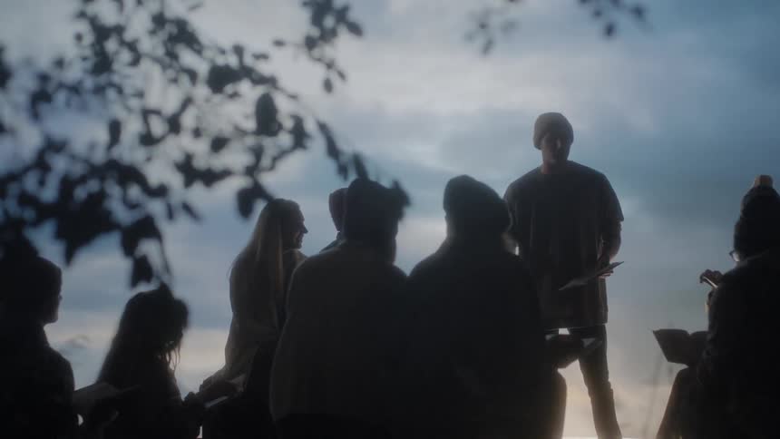 A group of people read together while outside