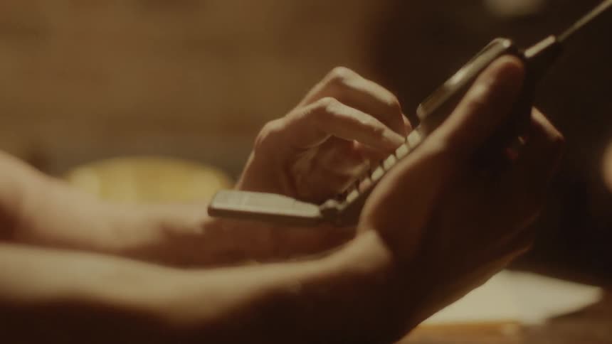 A man dialing a phone for a woman