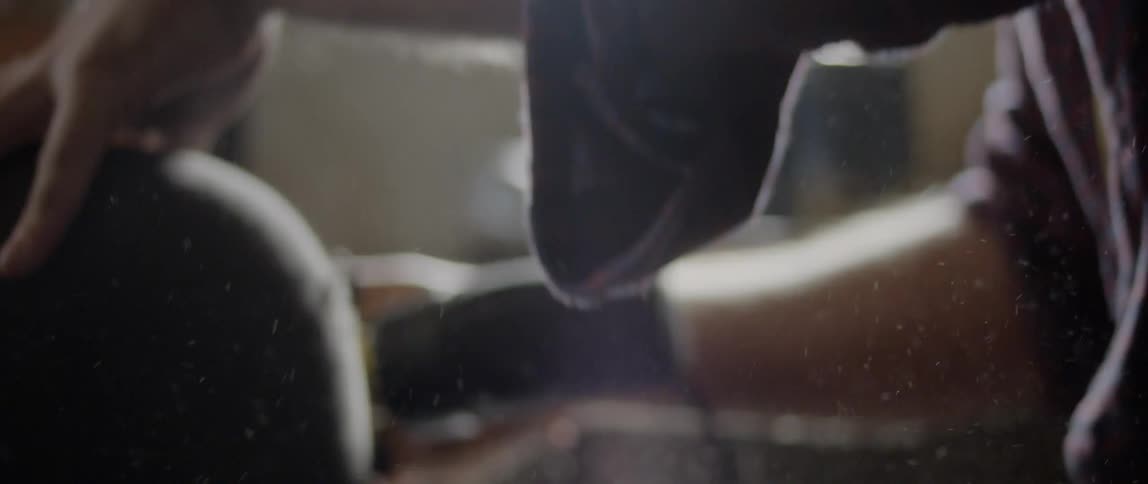 Man with tattoos works with power tools