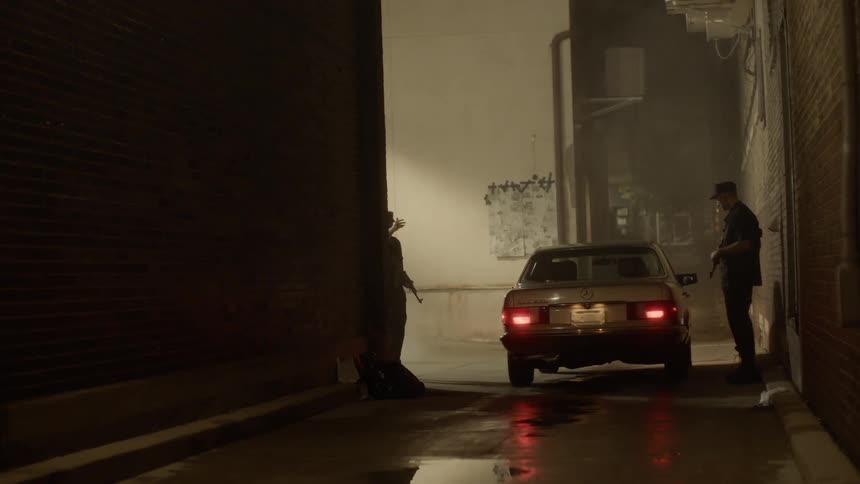 Two soldiers holding rifles allow the vehicle to pass after checking in the street at night