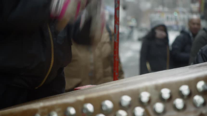 A street musician bangs on a large drum