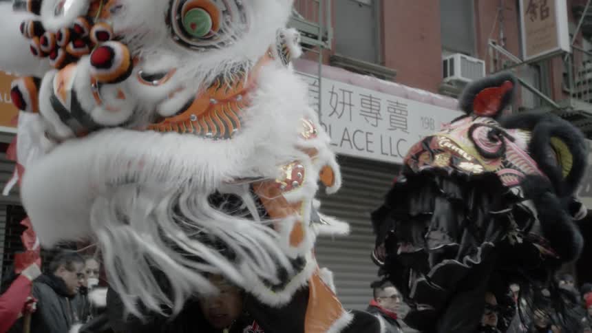 Costumed people perform on the street in front of the stores