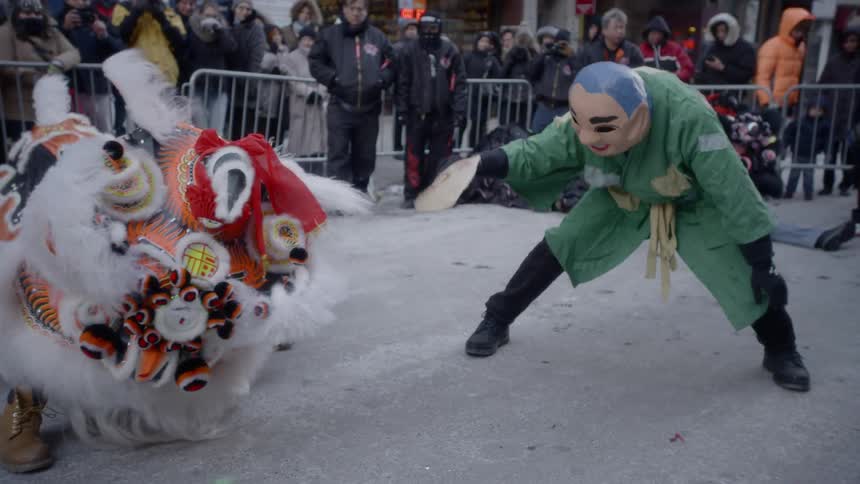 Dancers perform for an audience on the street