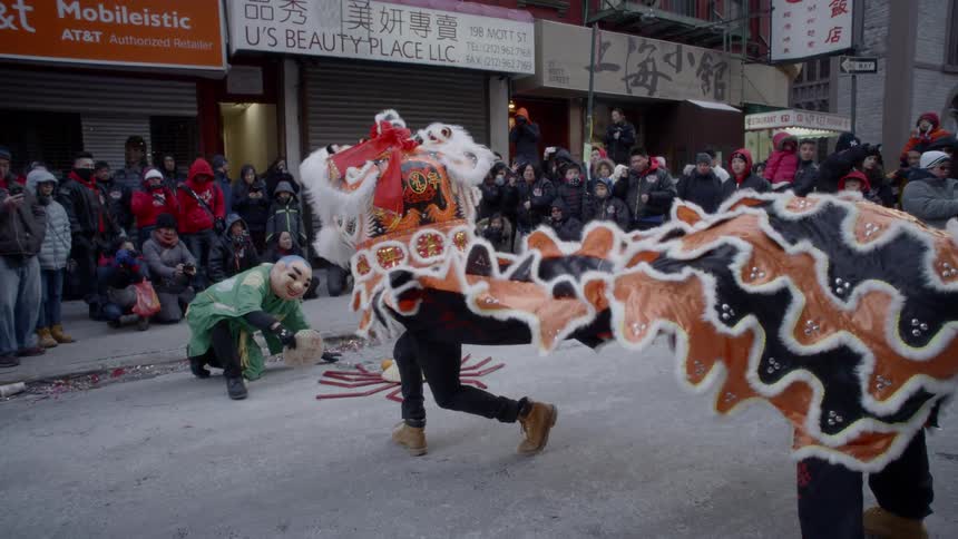 Dragon dance performed on a chinese street festival in front of crowd