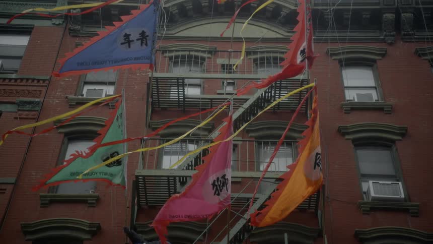 Colored flags flying in front of building