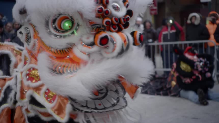 A chinese dragon dances in a parade in the city