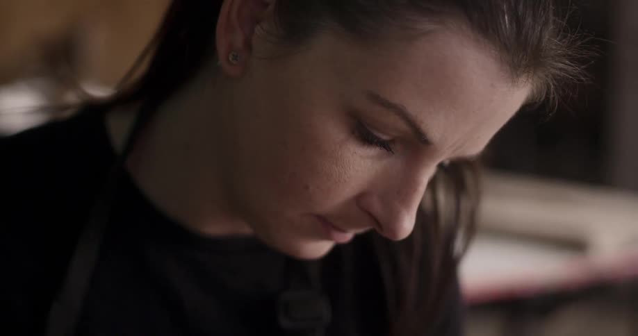 A woman stares downward