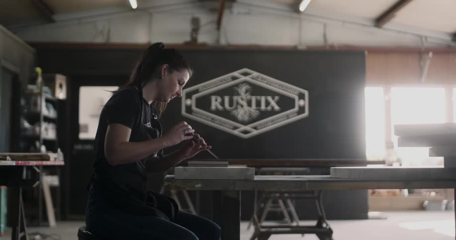 A female craftsman using a tool on a surface