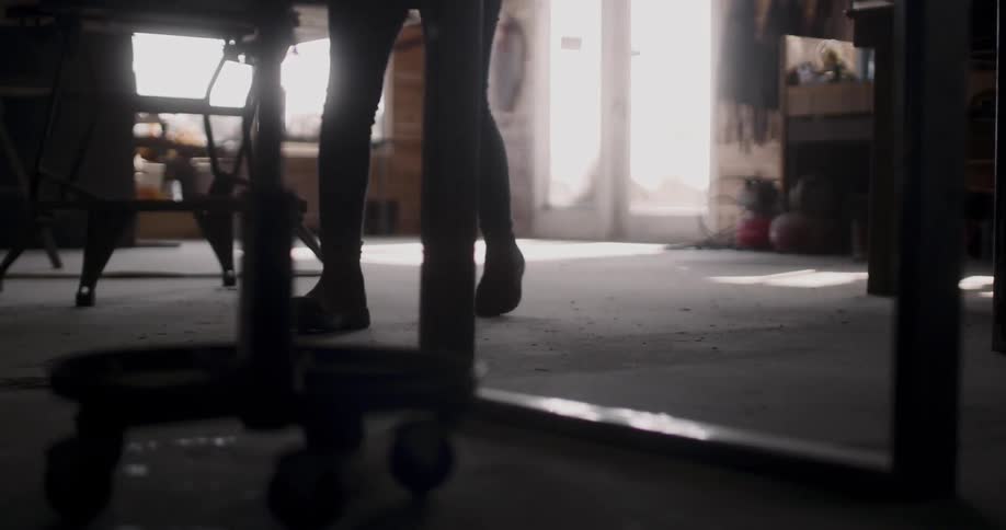 Silhouette of woman walking on workshop