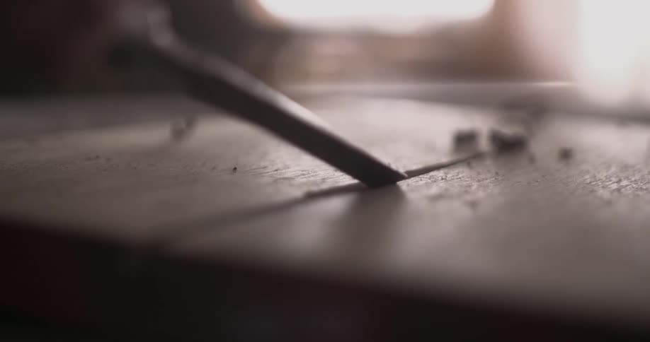 A chisel is used on a piece of wood
