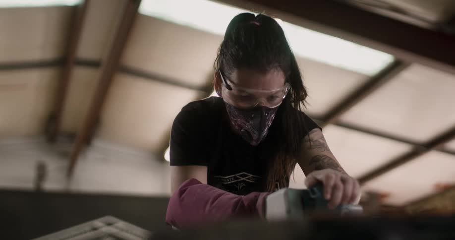 A woman works on sanding