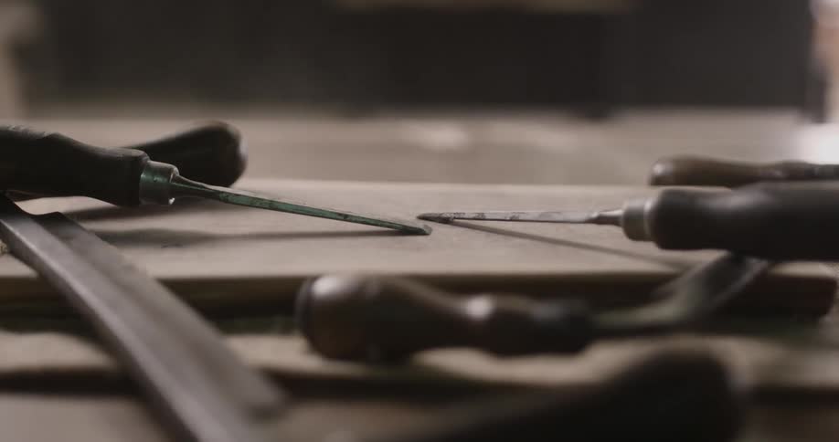 Tools sitting on a table as dust blows across them