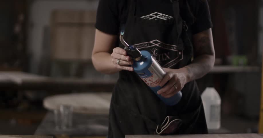 A woman holds a torch