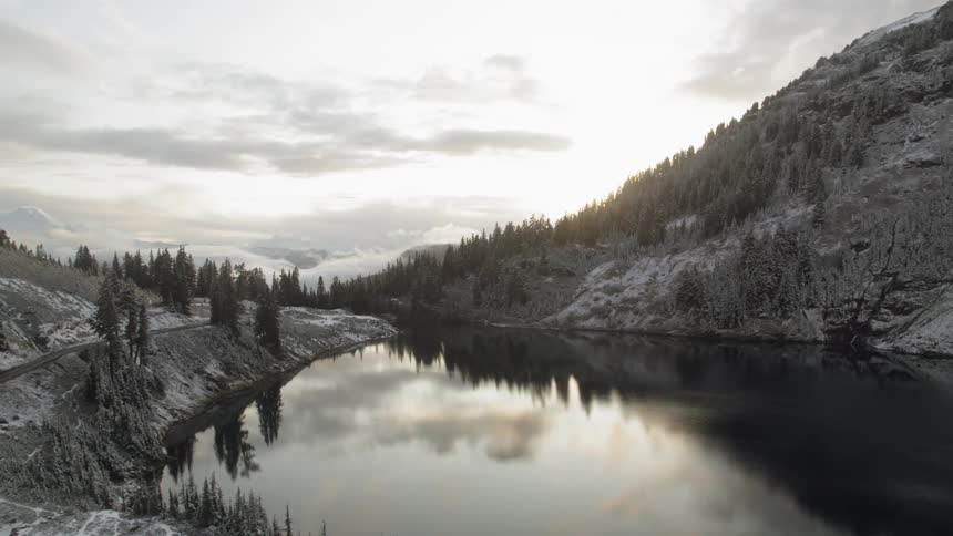 A lake sits nestled in a mountain valley