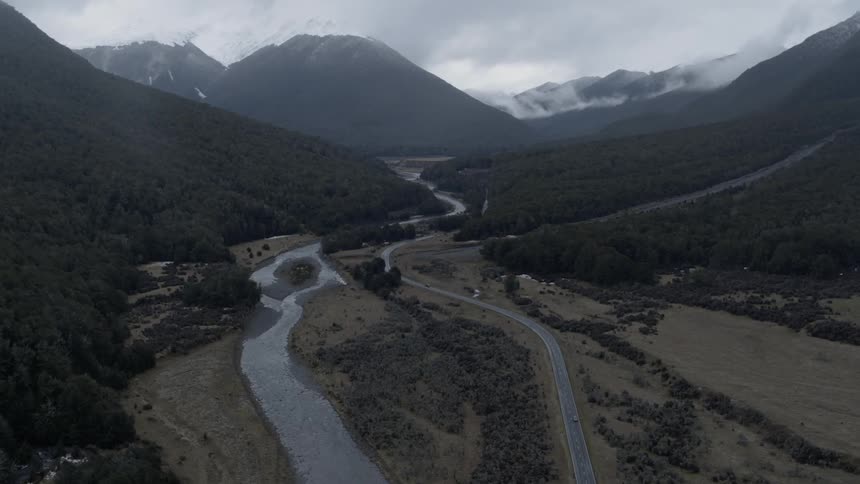 A car travels down a winding road in the mountains