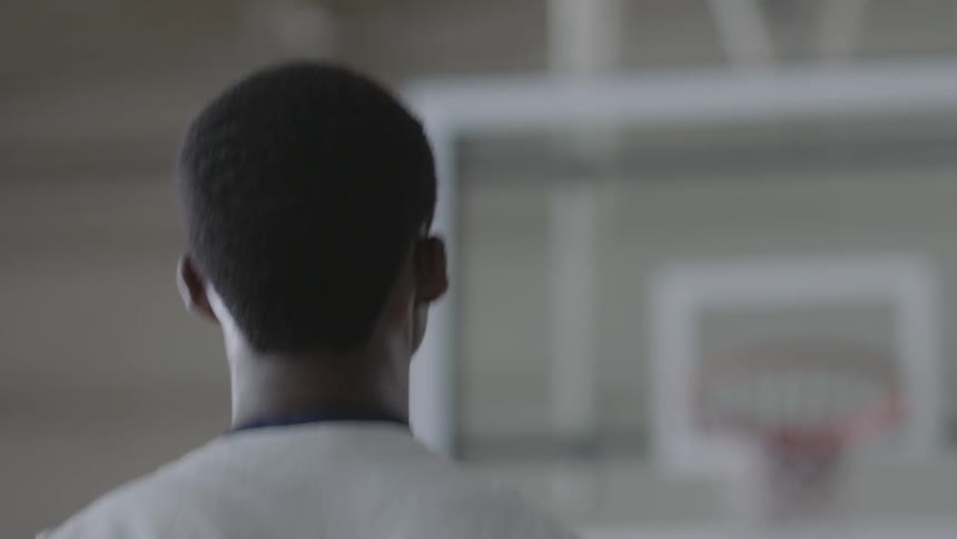 Man shoots a ball into the basket