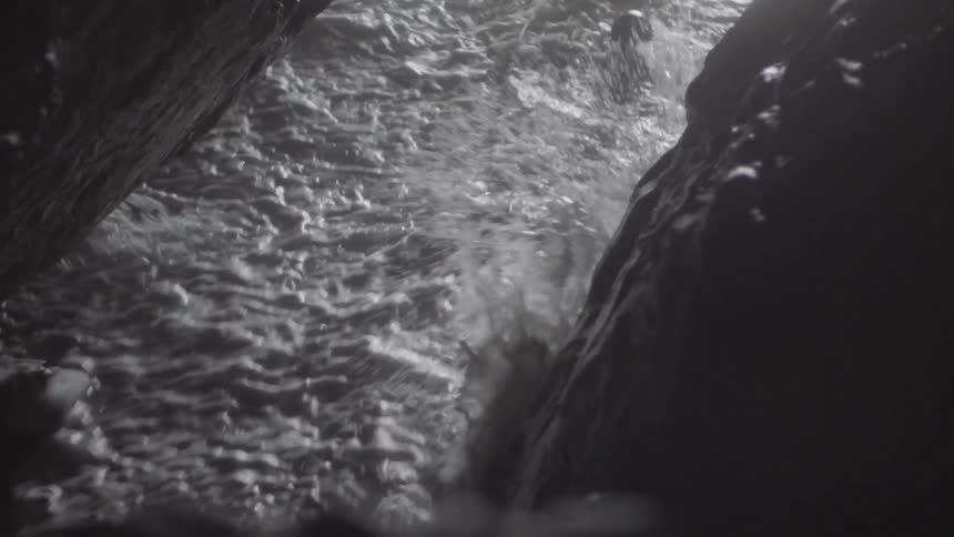 The tide washing a ball into a cave