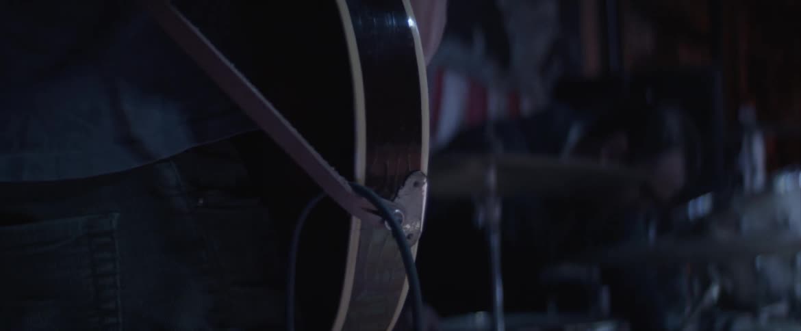 A guitarist plays next to a drummer