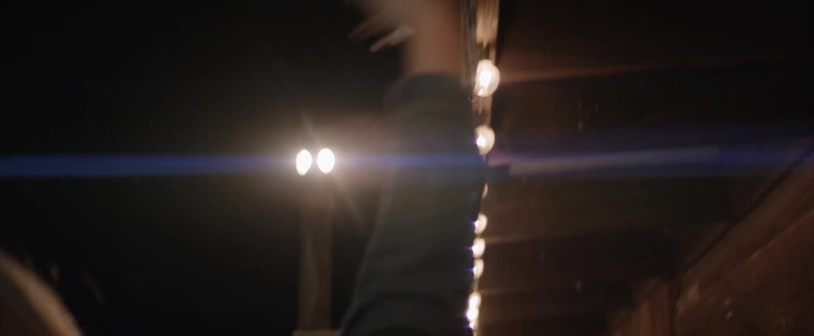 A person reaching out and touching lights