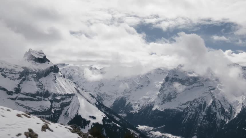 Landscape of snow capped mountains range with cloudy sky during daylight