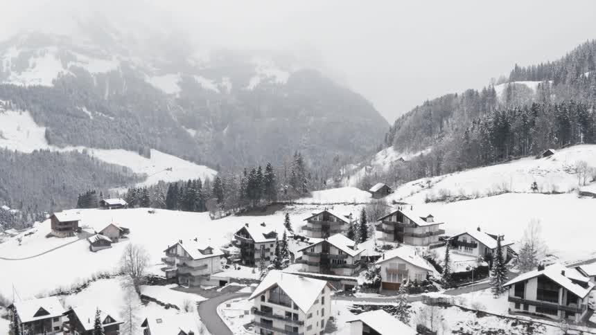 Snow is covering the neighborhood in winter