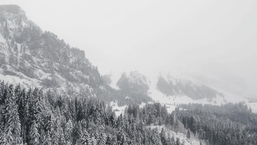 Snow falls in the mountains